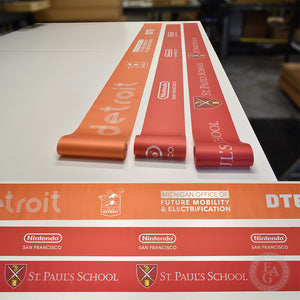 Two rolls of custom 6" full color printed ribbon and 1 roll of 8" ribbon