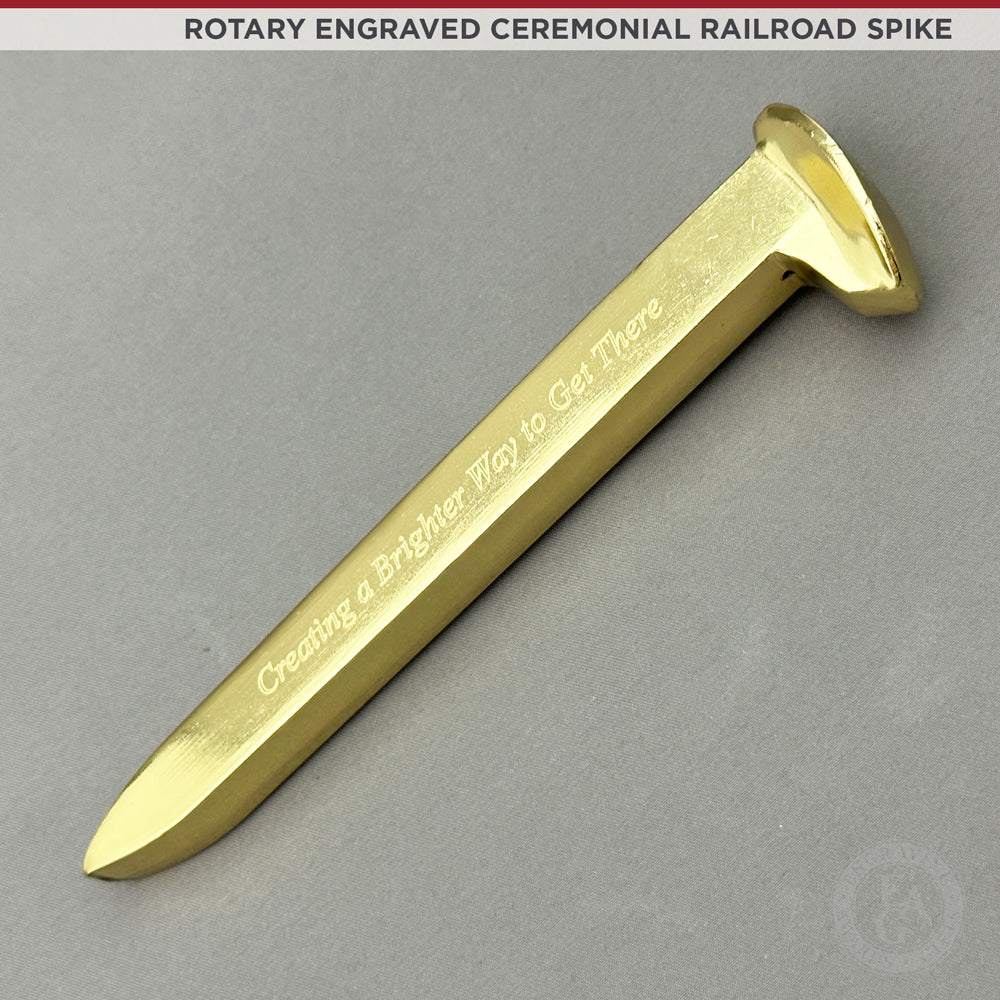 Sold at Auction: A railroad spike, gold plated with mark